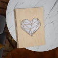 Segregator biurowy ze sklejki brzozowej z wyciętym geometrycznym sercem. Widok z góry.